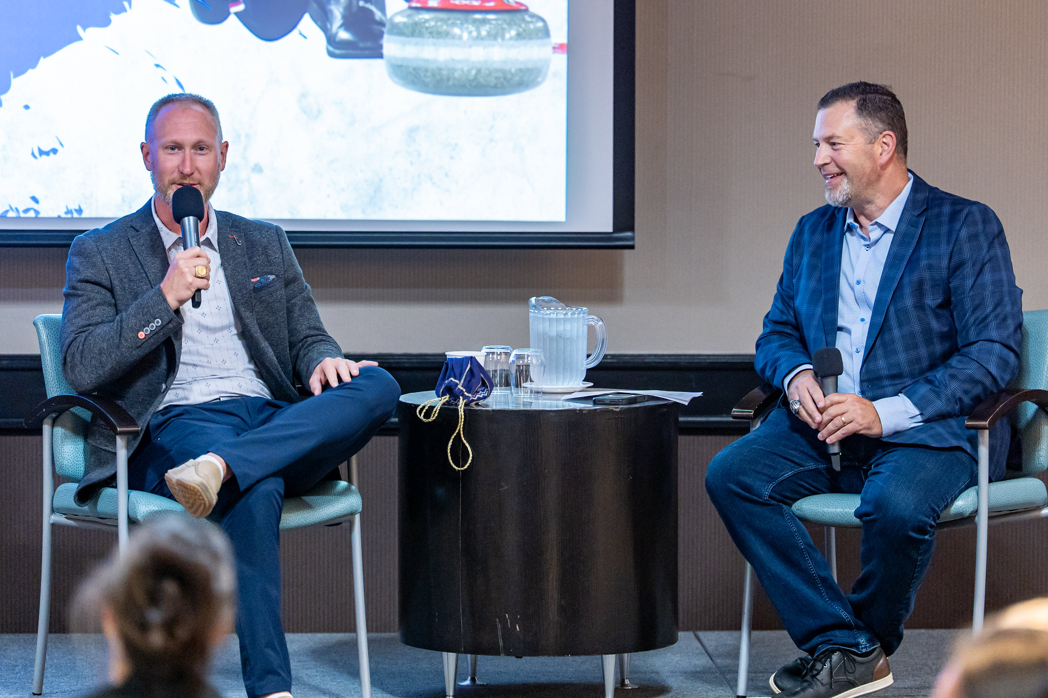 Brad Jacobs (left) and Paul Orazietti (right) share the stage during the featured community interview (Photo: Sault College Athletics)